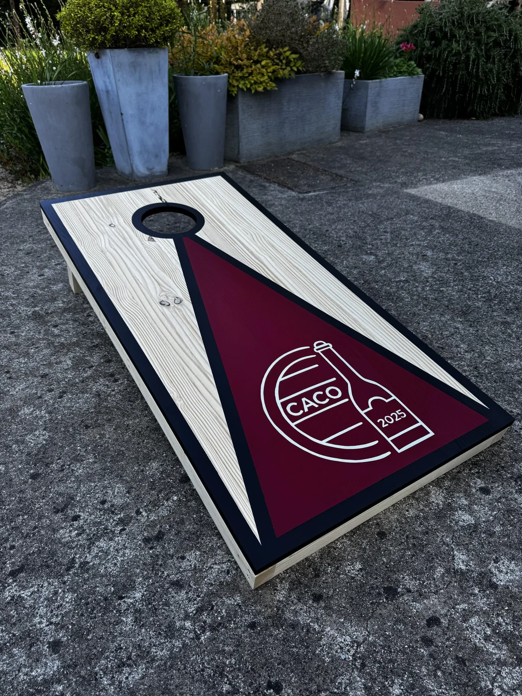 Cornhole personnalisé posé dans l’herbe